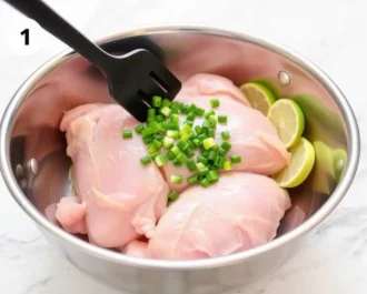 Chicken pieces sizzling in a pan.