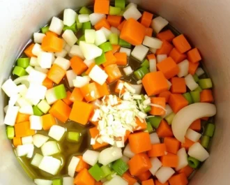 Bowl of creamy chicken and rice soup served hot as comfort food.
