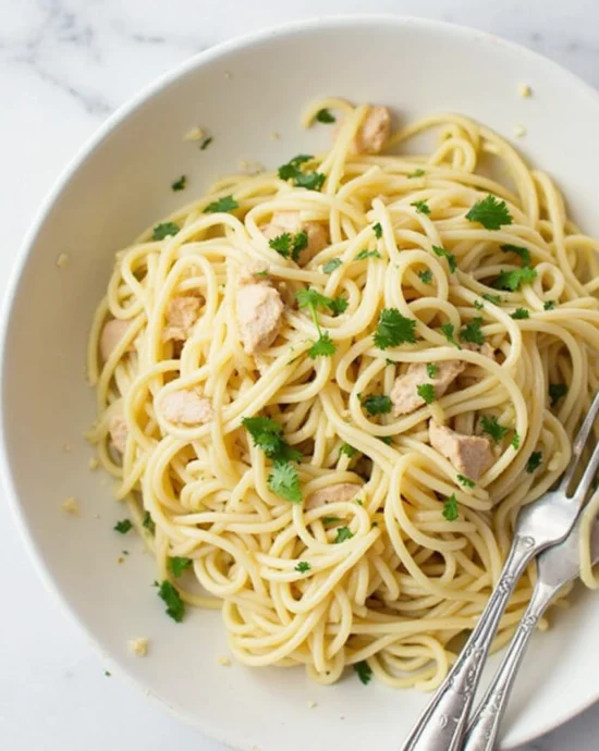 Marry me chicken pasta served on a plate with creamy sauce, sun-dried tomatoes, parmesan cheese, and fresh basil.