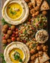 Creamy hummus dip served in a rustic bowl with olive oil drizzle – vegan mezze platter vegan recipe